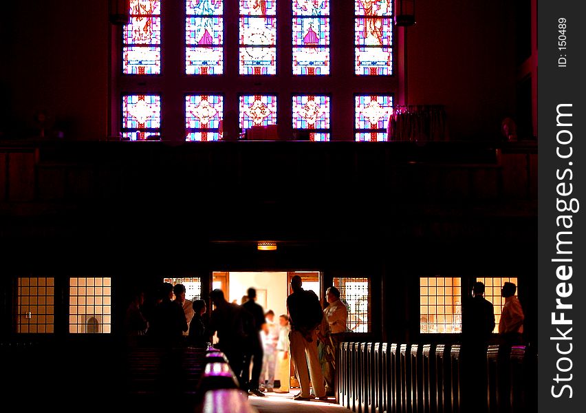 Parishioners congregating at the back of a Roman Catholic Church. Parishioners congregating at the back of a Roman Catholic Church