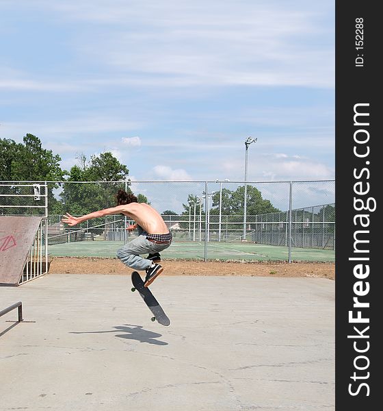 Teen skateboarder and board in air with shadow on ground. Shot with Canon 20D. Teen skateboarder and board in air with shadow on ground. Shot with Canon 20D.