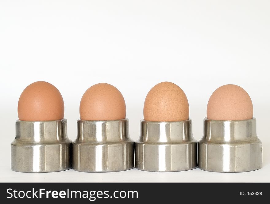 Four eggs in steel egg cups. Four eggs in steel egg cups