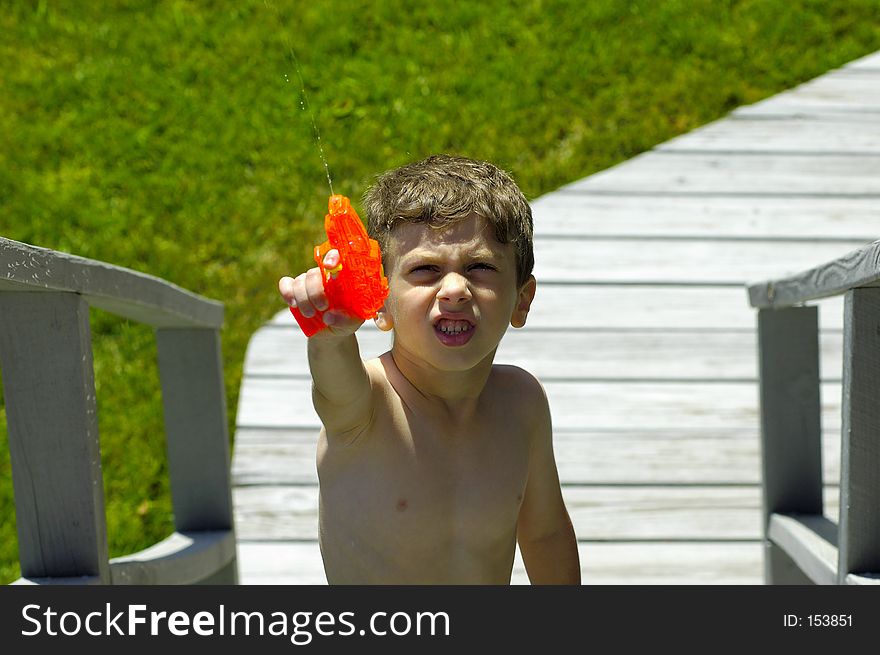 Child Outside With a Water Gun. Child Outside With a Water Gun.