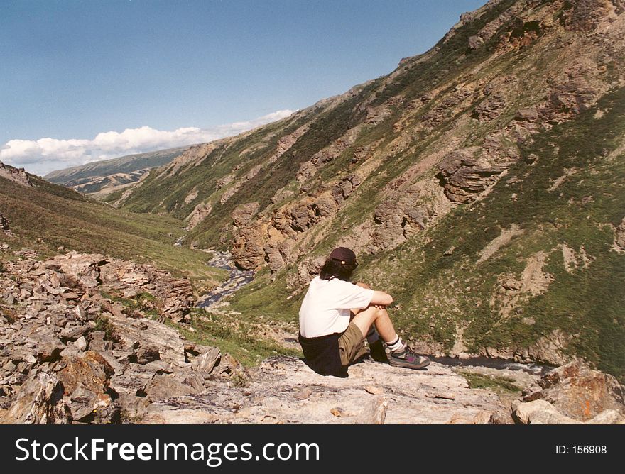 A young man overlooking the mountains in Alaska. A young man overlooking the mountains in Alaska