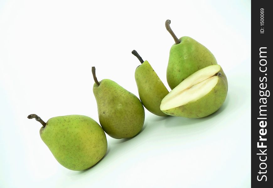 Whole and cut pears on white background