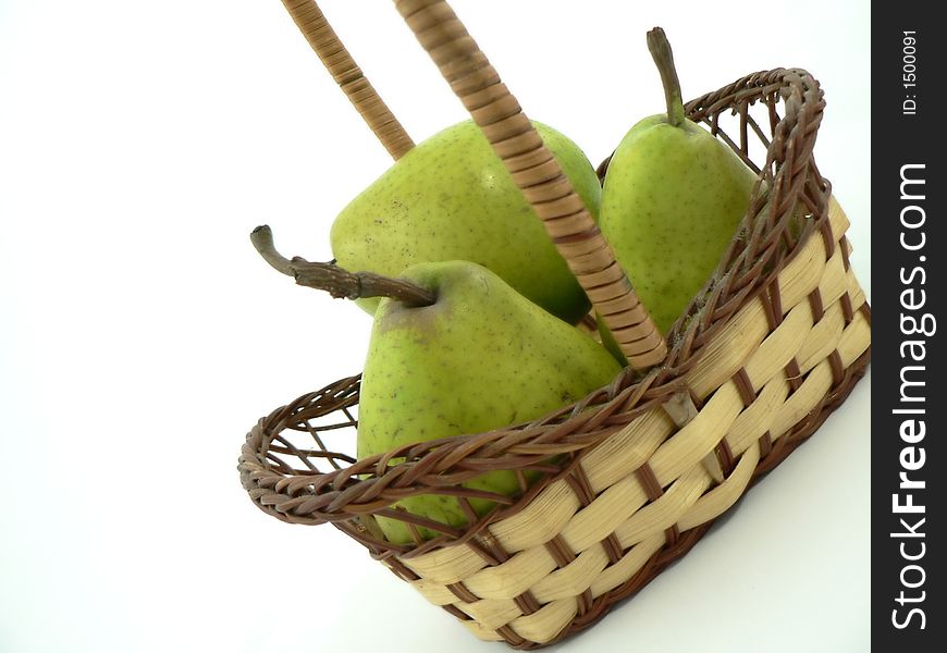 Whole and cut pears on white background