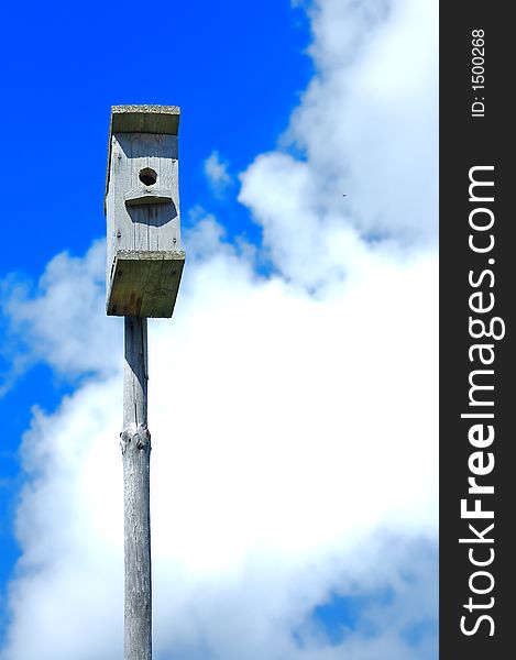 Nestling box in the blue summer sky. Nestling box in the blue summer sky