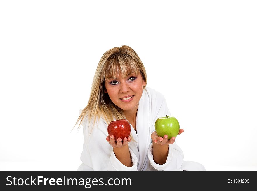 Young girl with two apples. Red and green. Focused on apples.