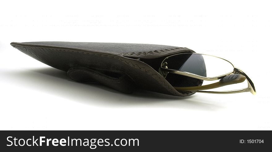 Close up of a pair of eye glasses in their soft leather case. Close up of a pair of eye glasses in their soft leather case