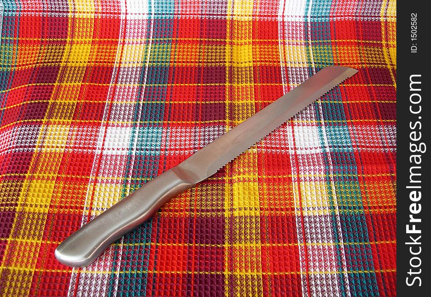Knife on a checkered fabric