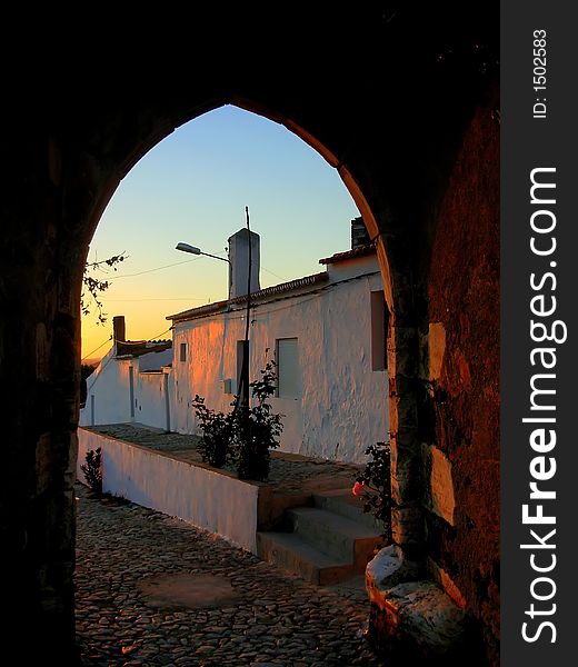 Urban landscape to the together twilight to the door of medieval castle. Portel, Portugal