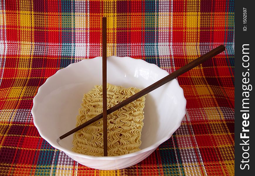 The welded noodles in a bowl with the Chinese sticks