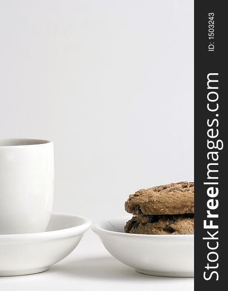 Coffee and Stack of Chocolate Chips cookies on white plate isolated on white background