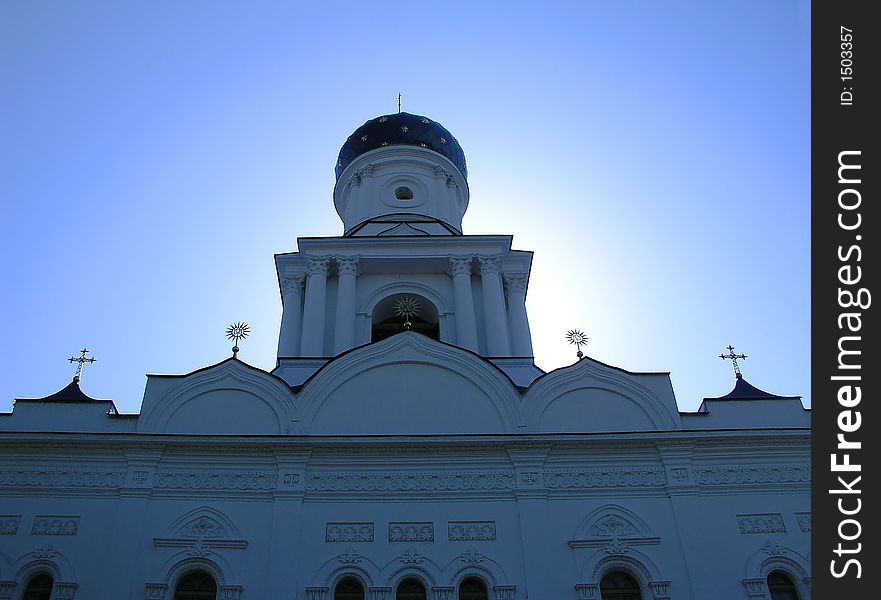 Orthodox church with a blue sky; the sun is behind the cupola of church. Orthodox church with a blue sky; the sun is behind the cupola of church