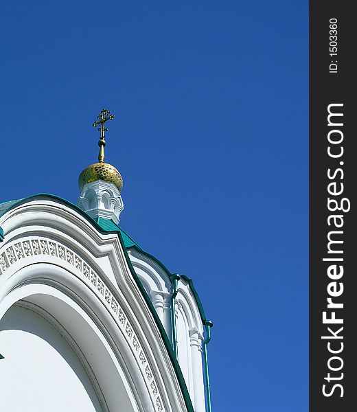 A church cupola and a cross against a sky background. A church cupola and a cross against a sky background