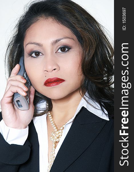 A woman dressed in a business suit, with telephone. A woman dressed in a business suit, with telephone