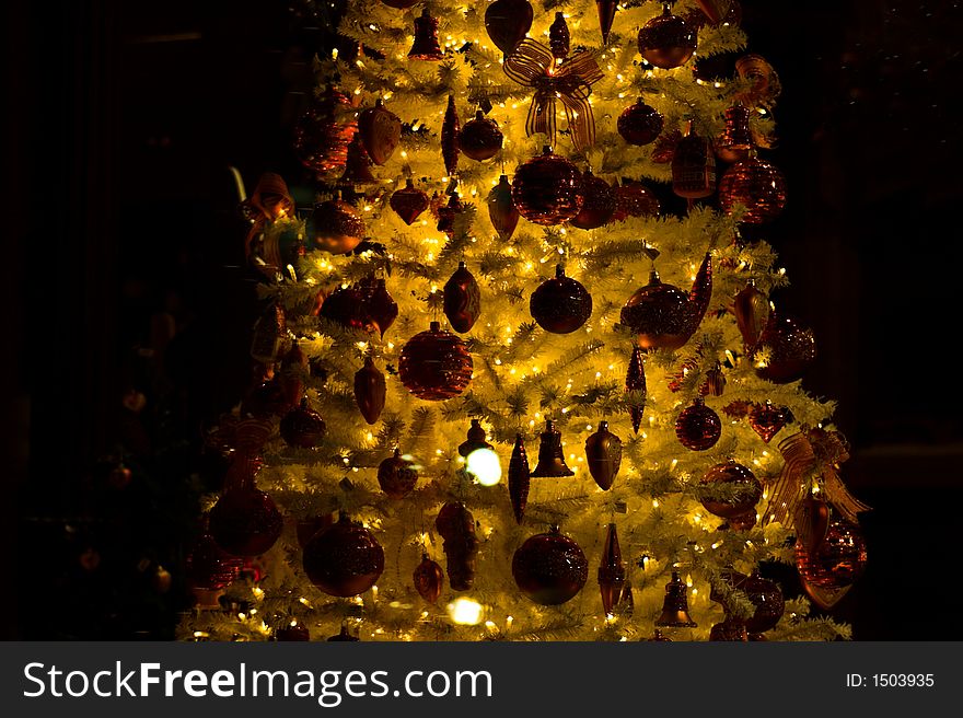Richly decorated christmas tree, glowing in the dark. Richly decorated christmas tree, glowing in the dark