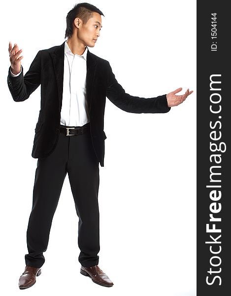 Great looking asian businessman shot in studio - pointing. Great looking asian businessman shot in studio - pointing