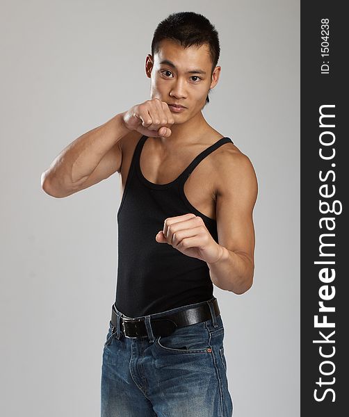 Great looking asian guy shot in studio - martial arts pose. Great looking asian guy shot in studio - martial arts pose