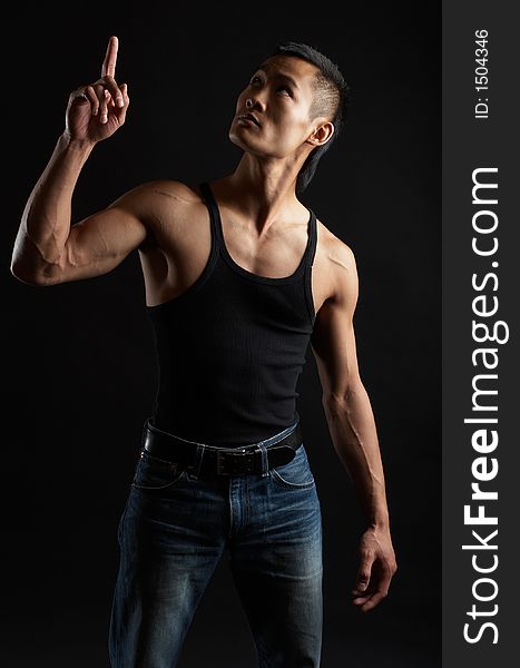 Great looking asian guy shot in studio - pointing upwards. Great looking asian guy shot in studio - pointing upwards