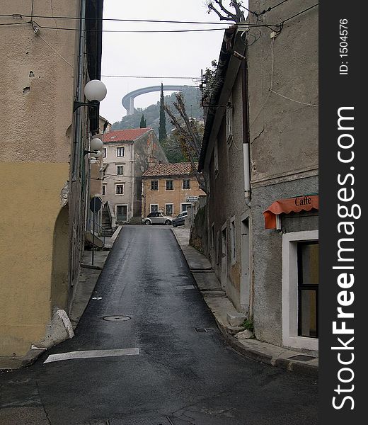 Small street with viaduct over small town, Croatia, Europe