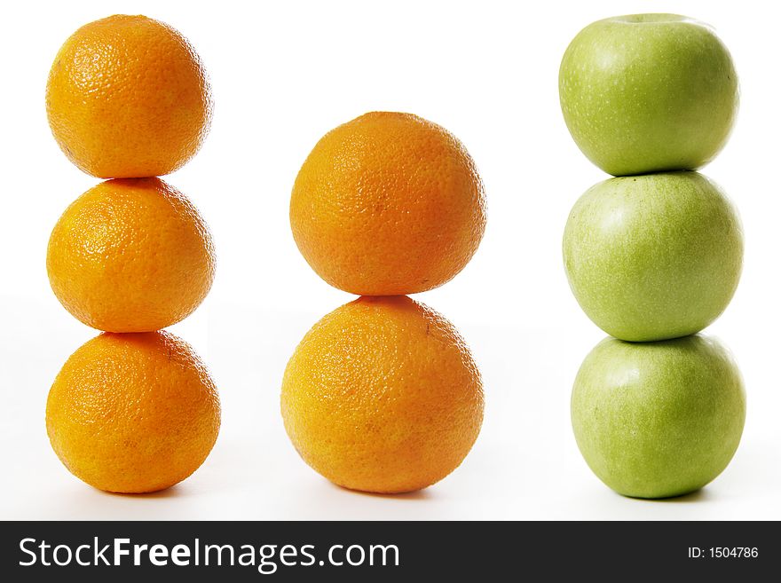 Stack of apples and oranges isolated on white background