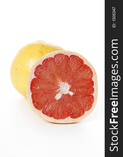 Isolated pink grapefruits, sliced piece in focus
