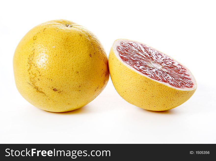 Isolated pink grapefruits, sliced piece in focus