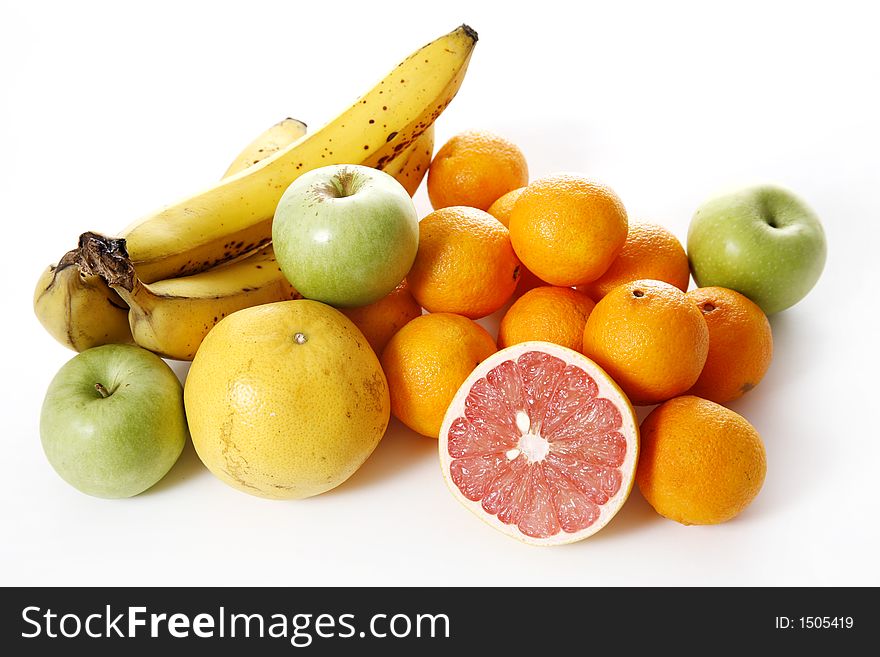 Assorted fruit over white - Includes grapefruit, clementines, bananas and apples