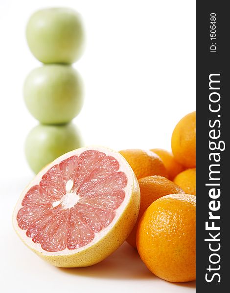 Assorted fruit over white - Apple stack in the background