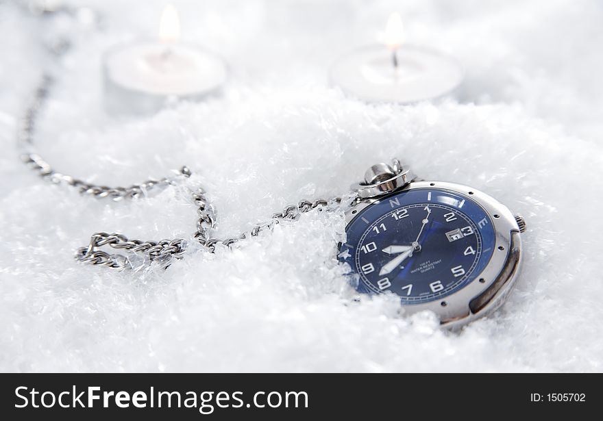 A nice looking pocket watch in snowflakes. A nice looking pocket watch in snowflakes