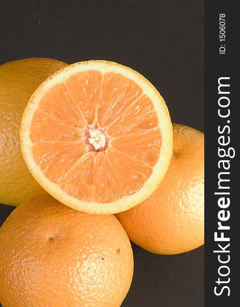 Freshly sliced half orange and oranges. Freshly sliced half orange and oranges