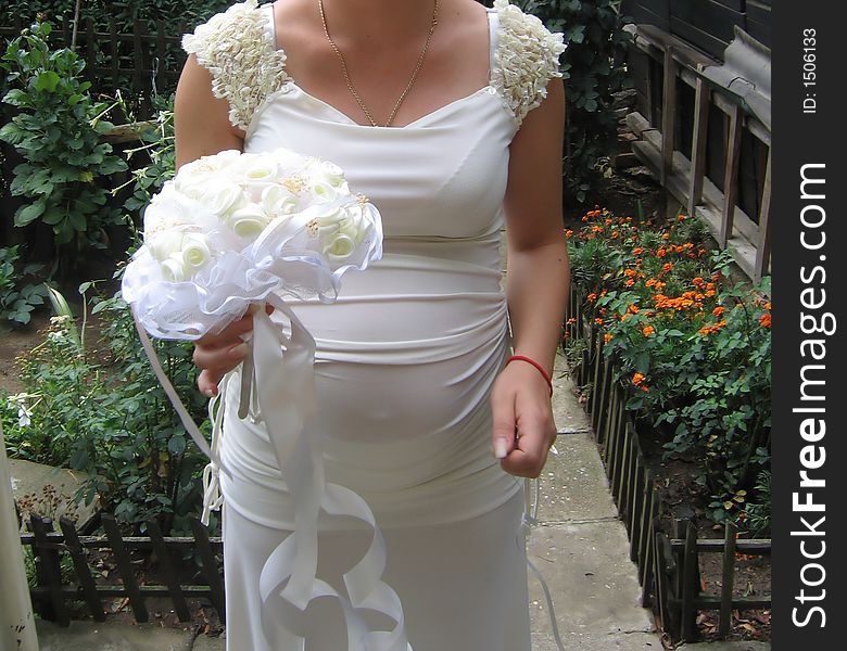 The bride holding a beautiful bouquet of white rouses. The bride holding a beautiful bouquet of white rouses