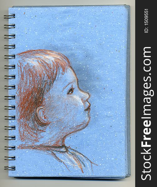 A drawing of child hand drawn with pencils and chalk on a blue sketchbook. A drawing of child hand drawn with pencils and chalk on a blue sketchbook