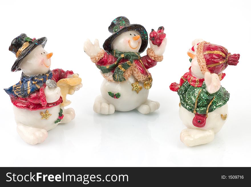 Miniature Snowman statues in different poses against white background with clipping paths. Miniature Snowman statues in different poses against white background with clipping paths