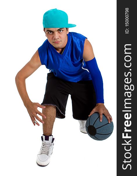 Young teenage basketball player in a studio setting with hip athletic clothing. Young teenage basketball player in a studio setting with hip athletic clothing.