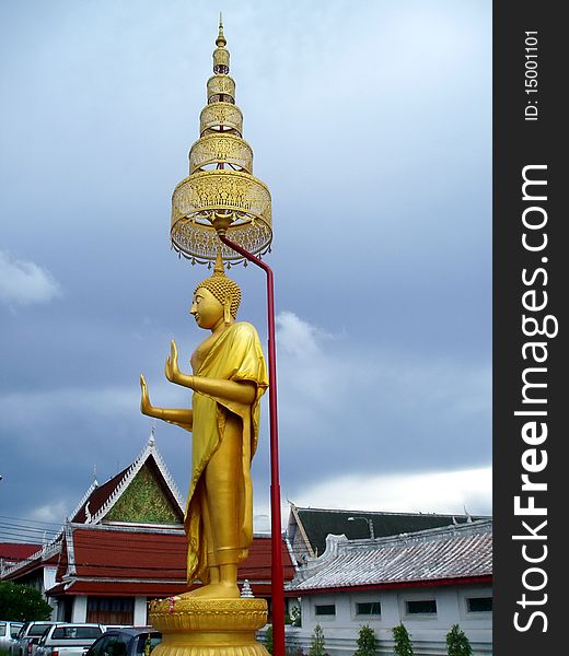 Beautiful stand buddha in front of temple.Stand buddha in golden tone color
with Thai art umbrella. Beautiful stand buddha in front of temple.Stand buddha in golden tone color
with Thai art umbrella.