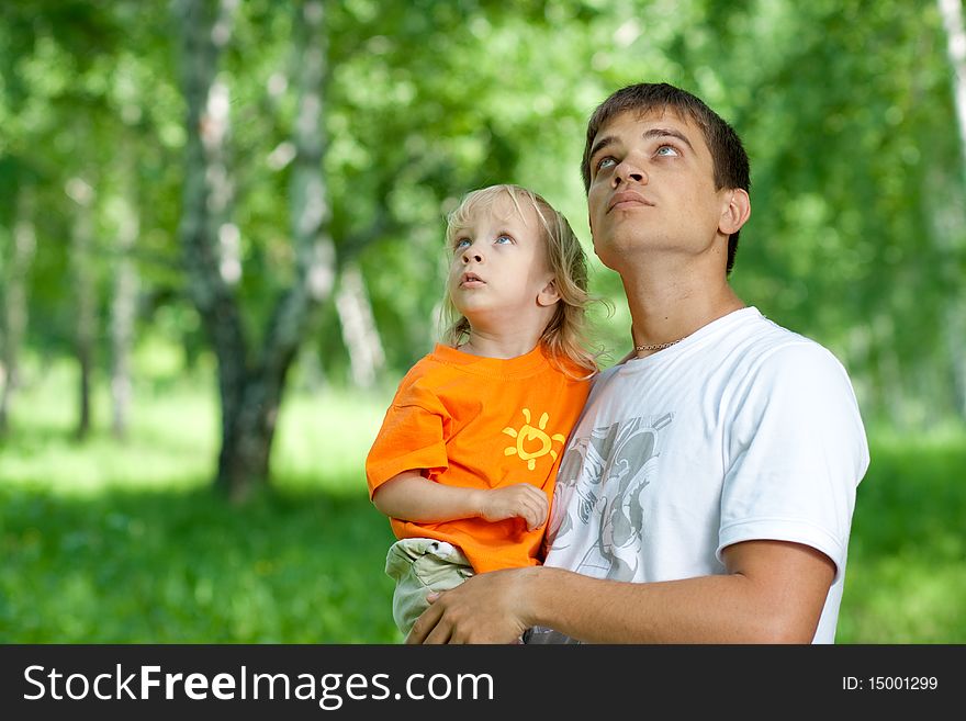Father and son in his hands watching up outdoors