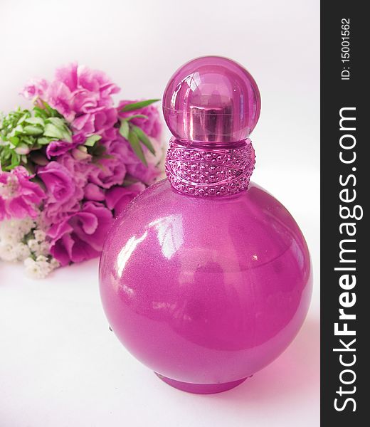 Bottle of perfume and flowers