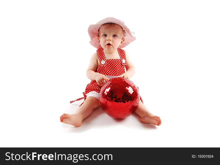 Little baby girl in red dress and hat with red ball