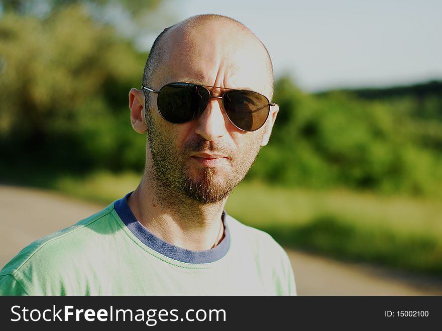 Man with sunglasses in middle of nature