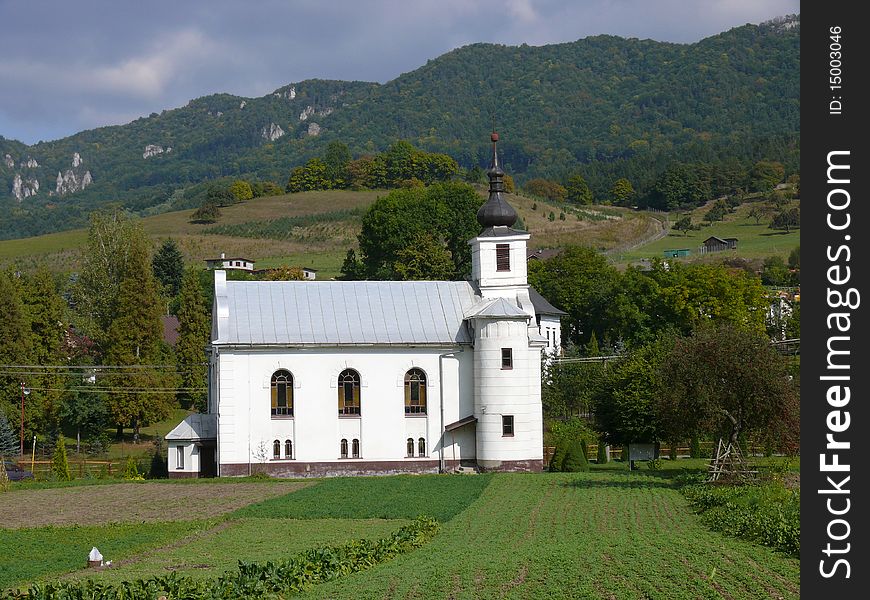 Church in the background rocks in the foreground field. Church in the background rocks in the foreground field