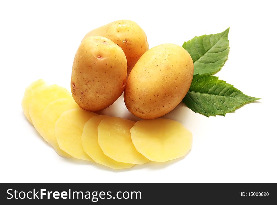 Isolated raw potatos with green leaves on white baclground. Isolated raw potatos with green leaves on white baclground