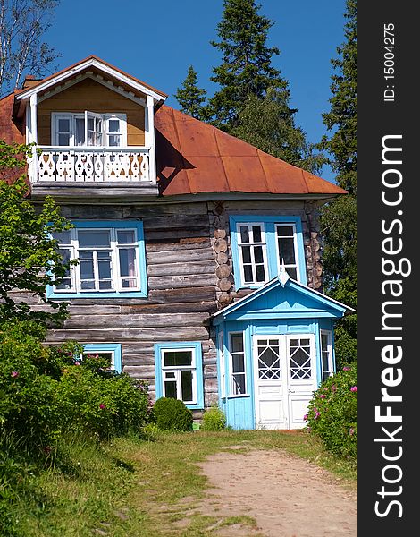 Exterior of traditional wooden house in countryside with trees in background, Karelia, Russian Federation. Exterior of traditional wooden house in countryside with trees in background, Karelia, Russian Federation.