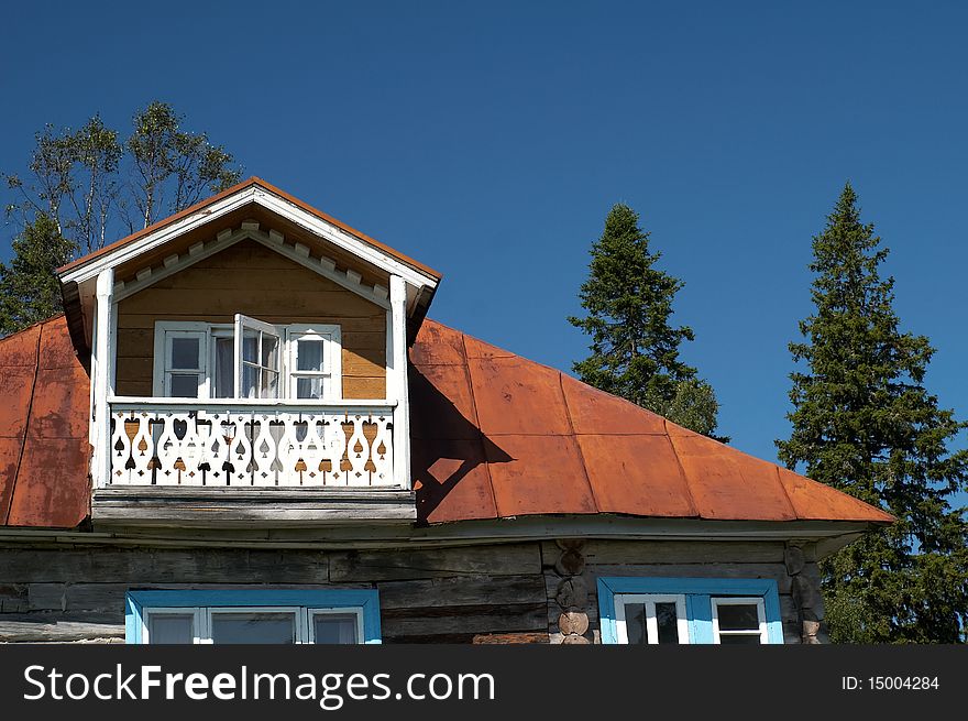 Exterior of traditional wooden house in countryside with trees in background, Karelia, Russian Federation. Exterior of traditional wooden house in countryside with trees in background, Karelia, Russian Federation.