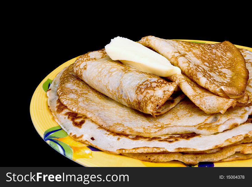 Fried pancakes with oil on a black background. Fried pancakes with oil on a black background