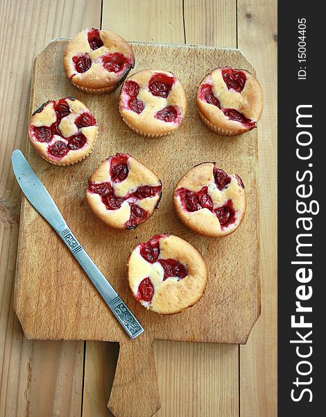 Delicious cherry muffin on a wooden table