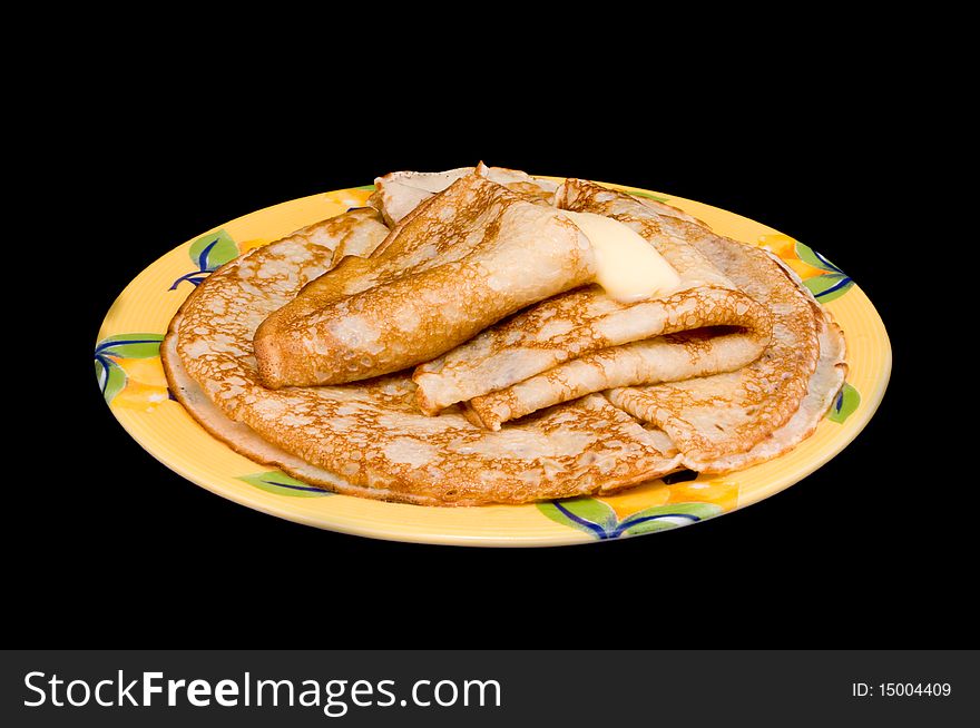 Fried pancakes with oil on a black background. Fried pancakes with oil on a black background