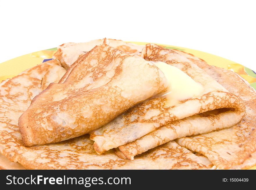 Pancakes with a butter on a white background