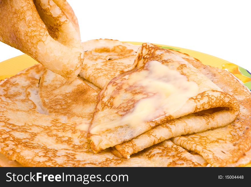 Pancakes with a butter on a white background