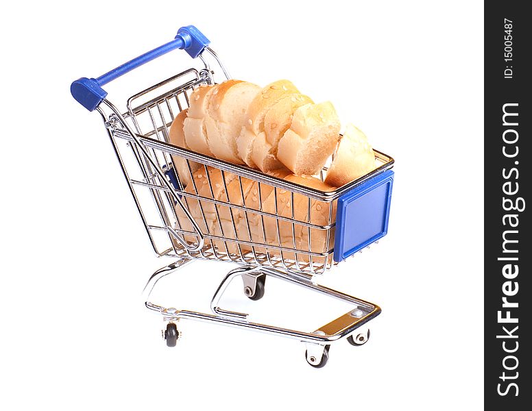 Metal shopping trolley filled with bread on yellow