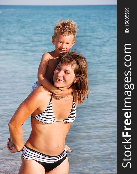 Happy mother and son on sea background