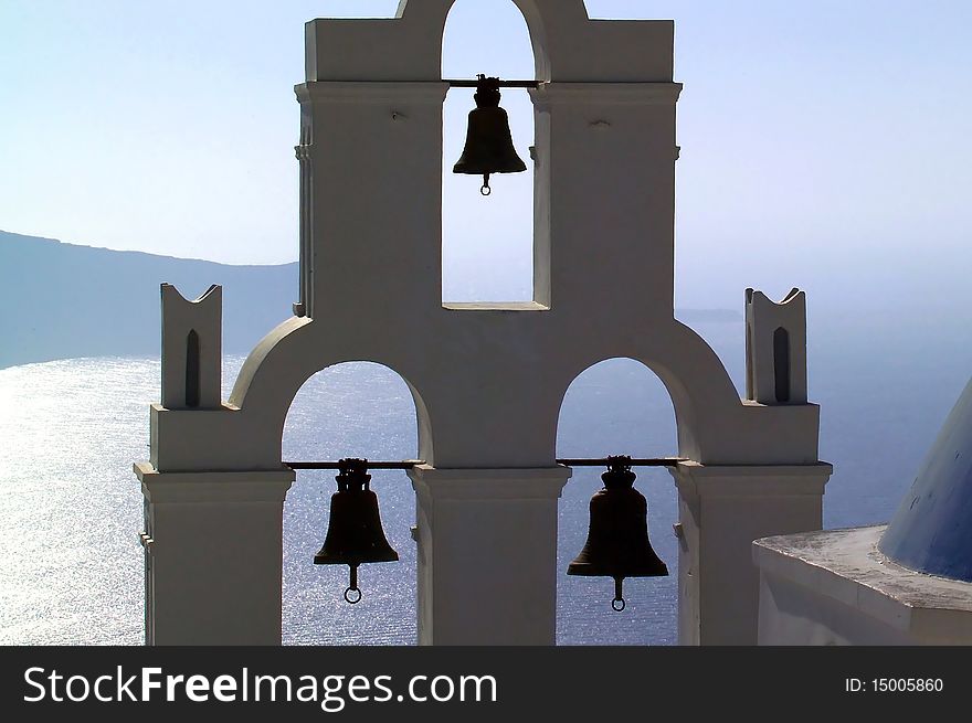 Greece santorini island lagoon with bells in foreground. Greece santorini island lagoon with bells in foreground